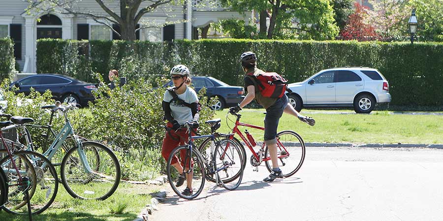 Young Adults Bicycling to Meeting