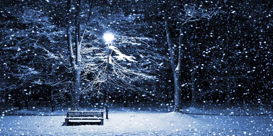 A blue wintery night, lamp post and bench